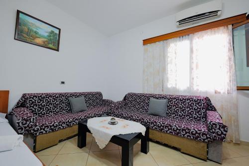 a living room with a couch and a table at Vila Limos in Ksamil