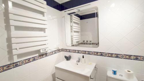 a white bathroom with a sink and a mirror at Estrella de O Vicedo in O Vicedo