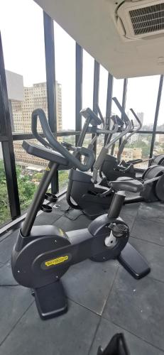 a row of exercise bikes in a gym at Urban Suites - Dolphin's Home in Jelutong
