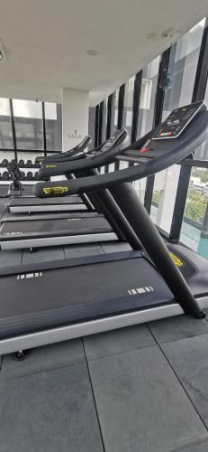 a row of treadles on a treadmill in a gym at Urban Suites - Dolphin's Home in Jelutong