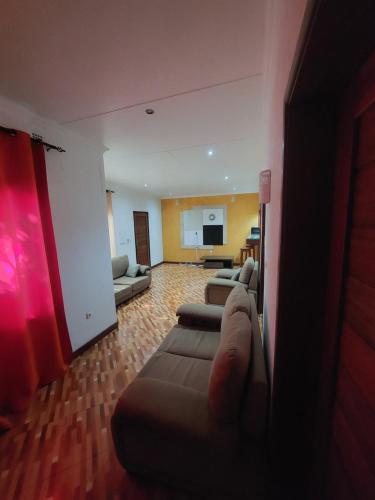 a living room with two couches and a living room with at Green Hill Lodge in Lopes