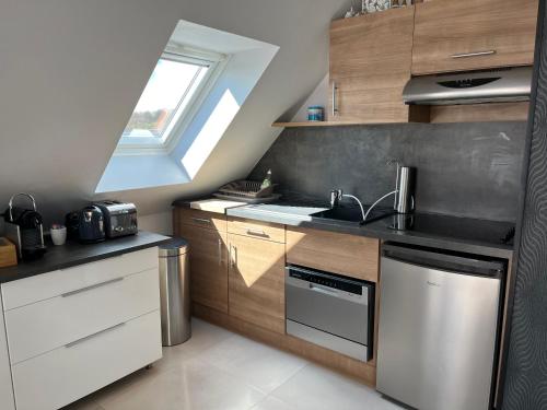 a small kitchen with a sink and a stove at Studio Strasbourg in Niederhausbergen