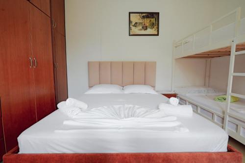 a bedroom with two beds and a bunk bed at Vila Limos in Ksamil