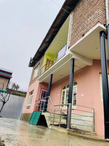 a house is inundated with water in a flooded street at Fab Ocean Guest House in Tangmarg