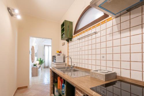 a kitchen with a sink and a window at Wish Apartment - Catania Centro Storico in Catania