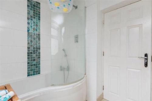 a white bathroom with a tub and a shower at Affordable and comfort apartment in Ibadan
