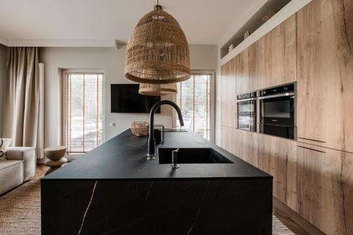 a kitchen with a black counter and a sink at Nautica Resort in Giżycko