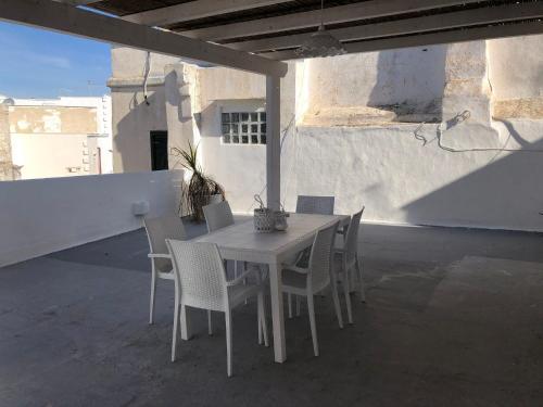a white table and chairs on a patio at Attico Belvedere in Gallipoli