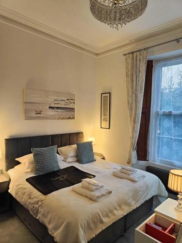a bedroom with a large bed with a chandelier at The Garway in Torquay