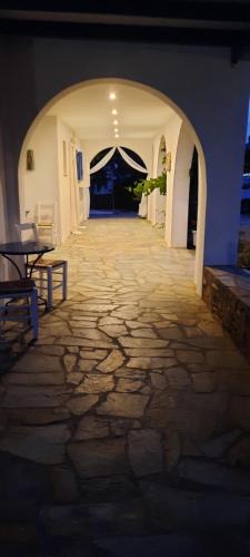 a stone walkway with a table and a tent at Galini me thea in Chrissi Akti