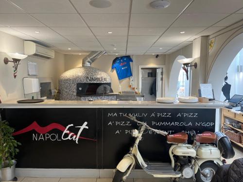 a motorcycle parked next to a counter in a store at Sorrento Hotel & Restaurant in Cambridge