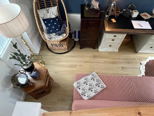 a living room with a couch and a desk at Roseberry Loft perfect for Wilton site in Nunthorpe