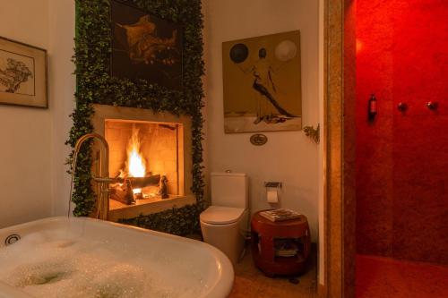 a bathroom with a bath tub and a fireplace at Sintra WOW - Unique double Smart Room in 17th century Palace! Hot tub, Snooker, BBQ, PS5, Sauna, Gym in Sintra