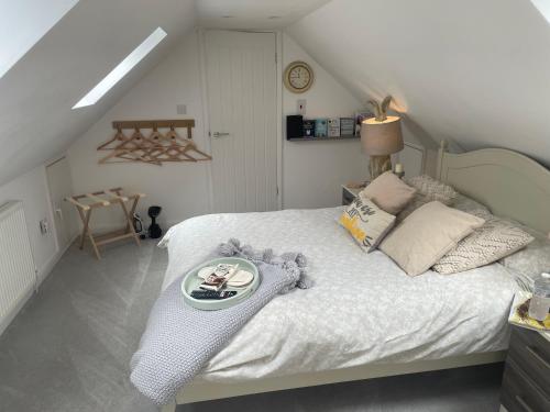 a bedroom with a bed with a tray of food on it at Roseberry Loft in Nunthorpe