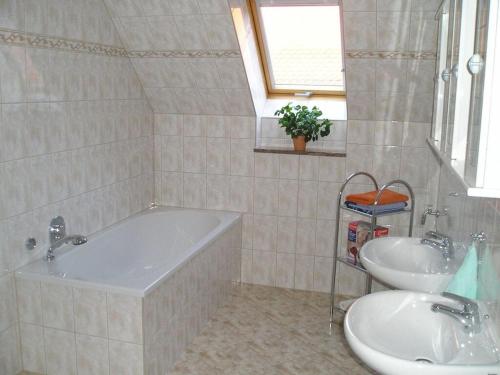 a bathroom with a tub and a sink at Sachon Modern Retreat in Dürrwicknitz
