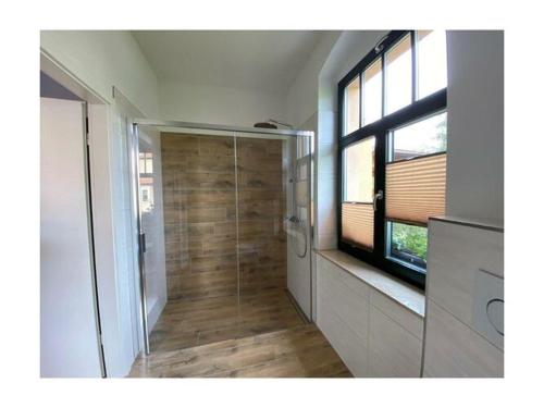 a bathroom with a shower with a glass door at Holiday apartment Boselblick in Meißen