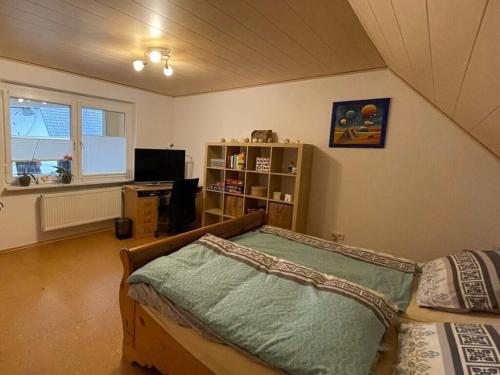 a bedroom with a bed in a room with a window at Holiday apartment Kromer in Jechtingen