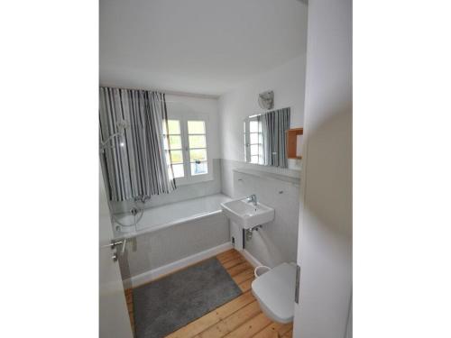 a bathroom with a sink and a tub and a toilet at Haus Rosa Comfortable holiday residence in Cochem