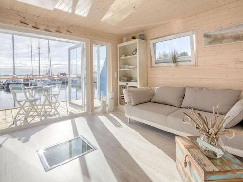 a living room with a couch and a large window at Baltic Sea Swantje Modern retreat in Heiligenhafen