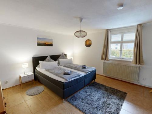 a bedroom with a large bed in a room at Eifel Oasis Comfortable holiday residence in Monschau