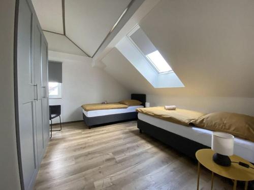 um quarto com 2 camas e uma clarabóia em Haus Mariechen Modern retreat em Frielendorf