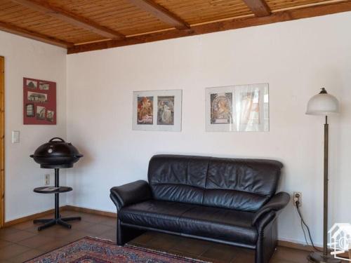 a black leather couch in a living room at Peter Lassau Modern retreat in Templin