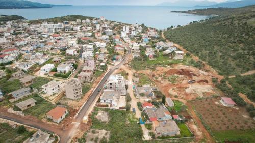 an aerial view of a city with the ocean at Vila Limos in Ksamil