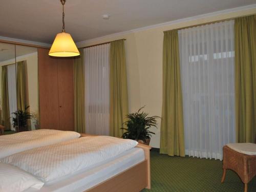 a bedroom with a bed and a large window at Haus Jörg Sosna Modern retreat in Bad Bayersoien