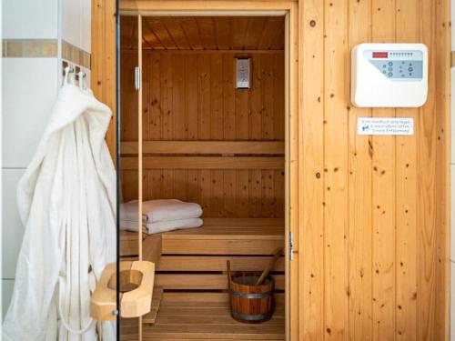 a sauna with a bed in a wooden cabin at Beach house Dune 19 - Serenity in Neuhaus