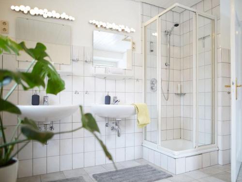 a bathroom with two sinks and a shower at The parents' house Modern retreat in Clausthal-Zellerfeld