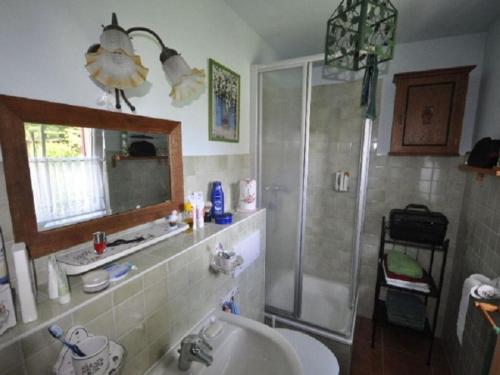 a bathroom with a sink and a shower at Red-throated diver Modern retreat in Putgarten