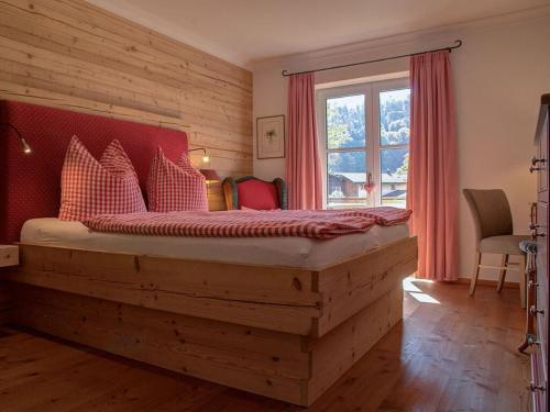 a bedroom with a large wooden bed with a window at Castle view Modern retreat in Oberhof