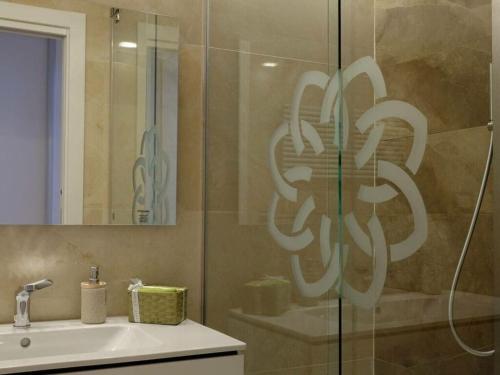 a bathroom with a shower with a sink and a mirror at Royal Suite Sarzana in Sarzana