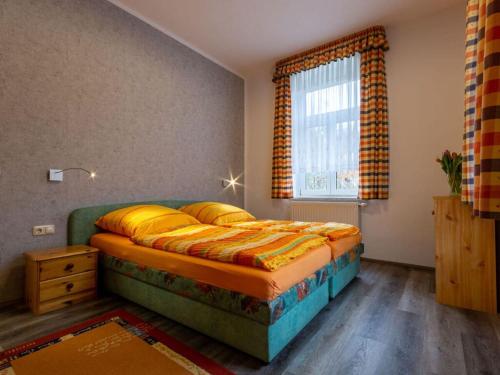 a bedroom with a bed and a window in a room at Holiday apartments Ender in Sebnitz