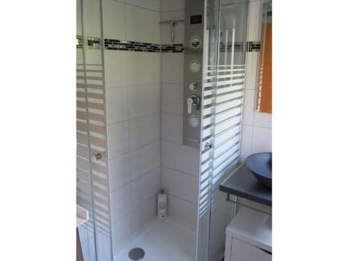 a shower with a glass door in a bathroom at Sunshine Modern Retreat in Ronshausen