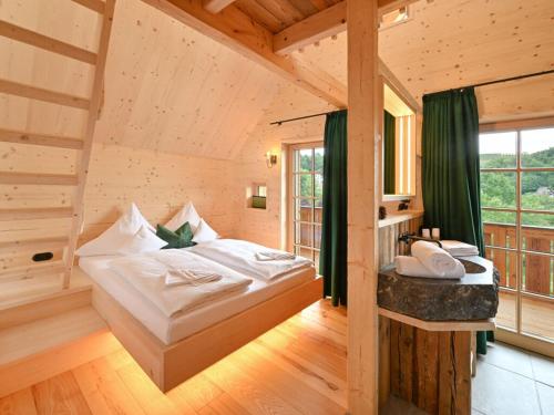 a bedroom with a bed in a wooden house at Grandma Ludwin 1 Modern retreat in Sasbachwalden
