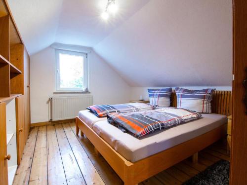 a bedroom with a bed in a attic at Holiday apartment Alstaden 1 in Oberhausen