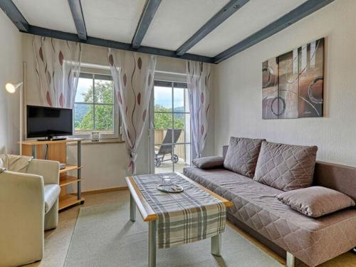 a living room with a couch and a table at Holiday apartment Haus Leutner Bavarian Forest in Bodenmais
