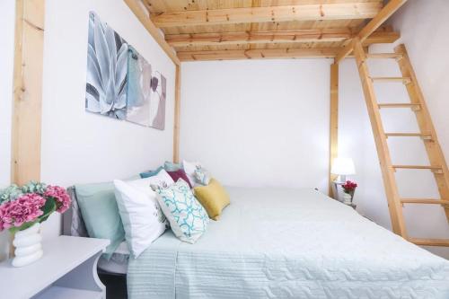 a bedroom with a bed with a ladder at Casa Niovi, Acharavi in Acharavi