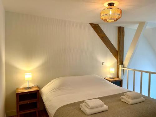 a bedroom with a bed with two towels on it at Appartement Sneek in Sneek