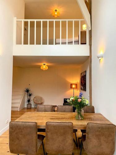 a dining room with a wooden table and chairs at Appartement Sneek in Sneek