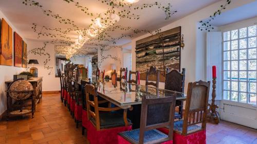 a room with a counter with chairs and a table at Sintra WOW - Unique double Smart Room in 17th century Palace! Hot tub, Snooker, BBQ, PS5, Sauna, Gym in Sintra