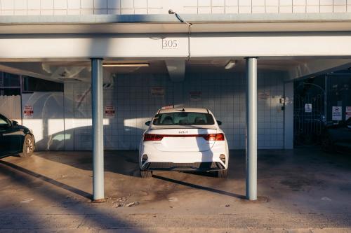 a white car parked in a parking garage at Waikiki Heritage Hotel in Honolulu