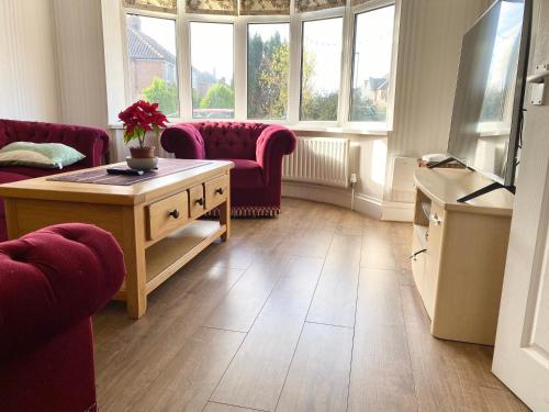 a living room with a couch and a table at Spacious Five-Bedroom House Close to York Centre - Orchid House in York