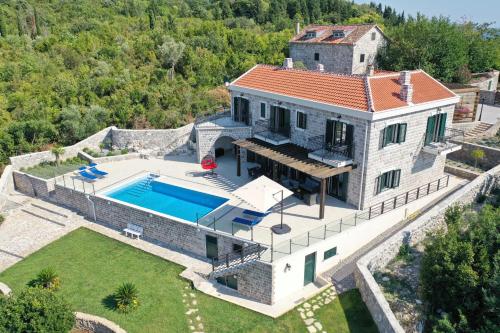 an aerial view of a house with a swimming pool at Villa Vista Azzurra in Tivat