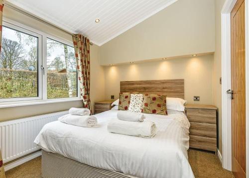 a bedroom with a large bed and a window at Crake Valley in Torver