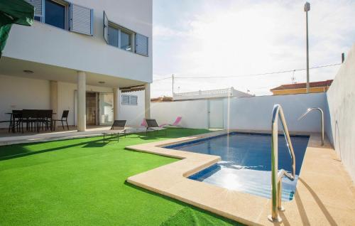 a house with a swimming pool and green grass at 3 Bedroom Amazing Home In El Mojón in El Mojón