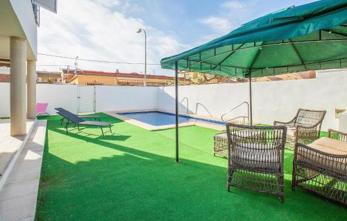 a patio with chairs and a swimming pool at 3 Bedroom Amazing Home In El Mojón in El Mojón