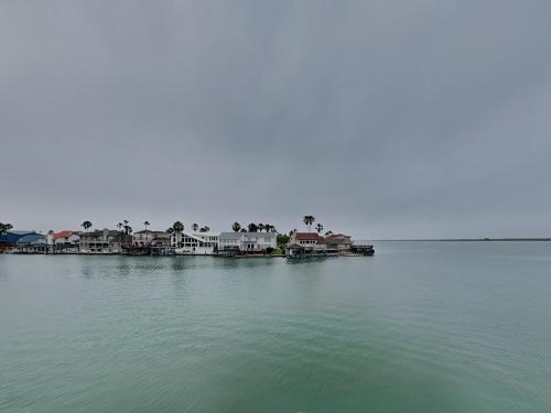 a group of houses on the shore of a body of water at Sunset Water View in Padre Island