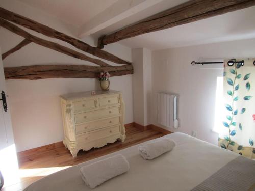 a bedroom with a white bed and a dresser at Cerisier in Étusson